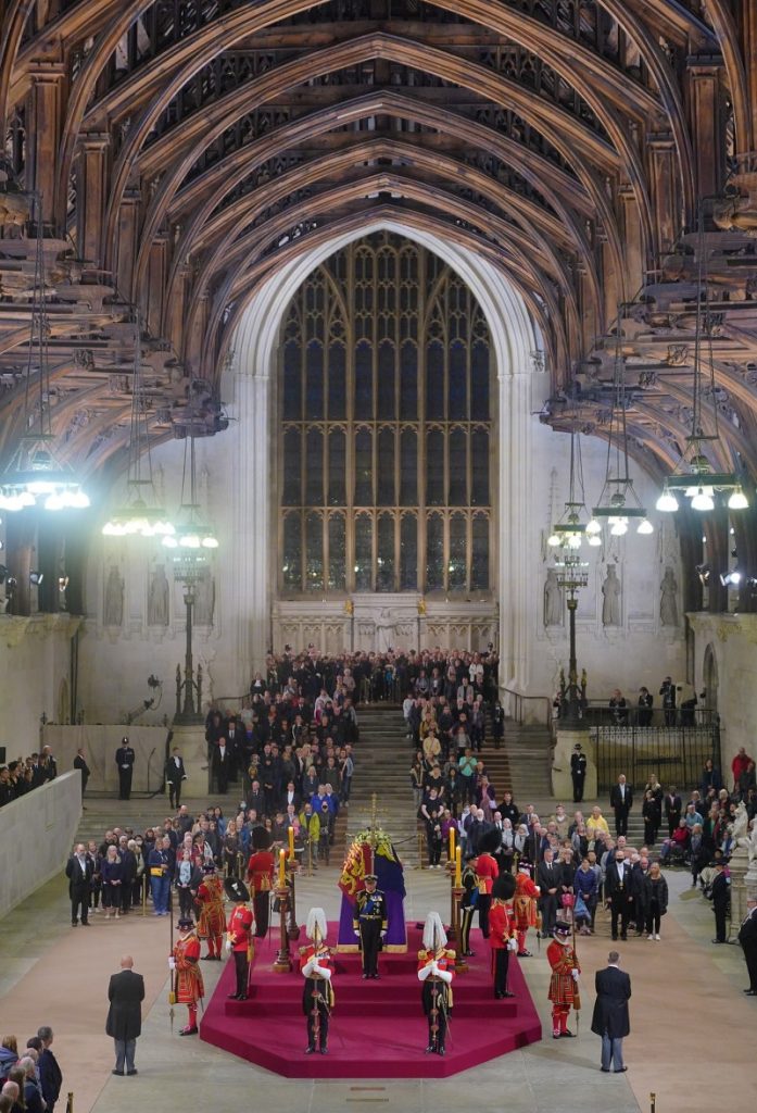 Queen's coffin lying in state while mourners pass by